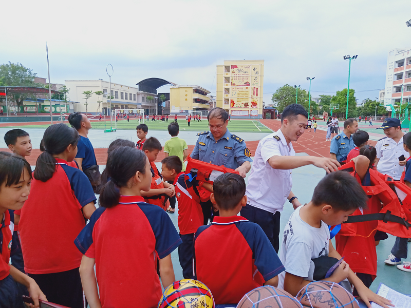 崇左市港航管理局、广西崇左海事处工作人员为学生讲解救生衣穿戴方法.png