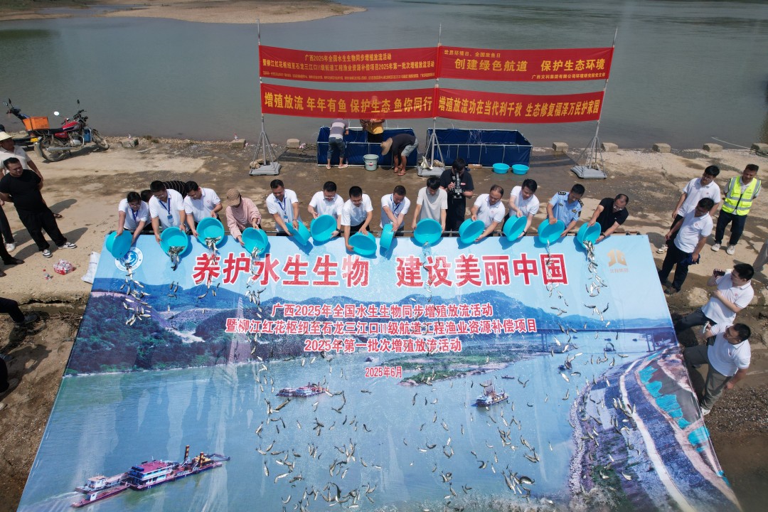 1749438275361027645.jpg 参加活动代表一同将鱼苗投放入水中(一).jpg