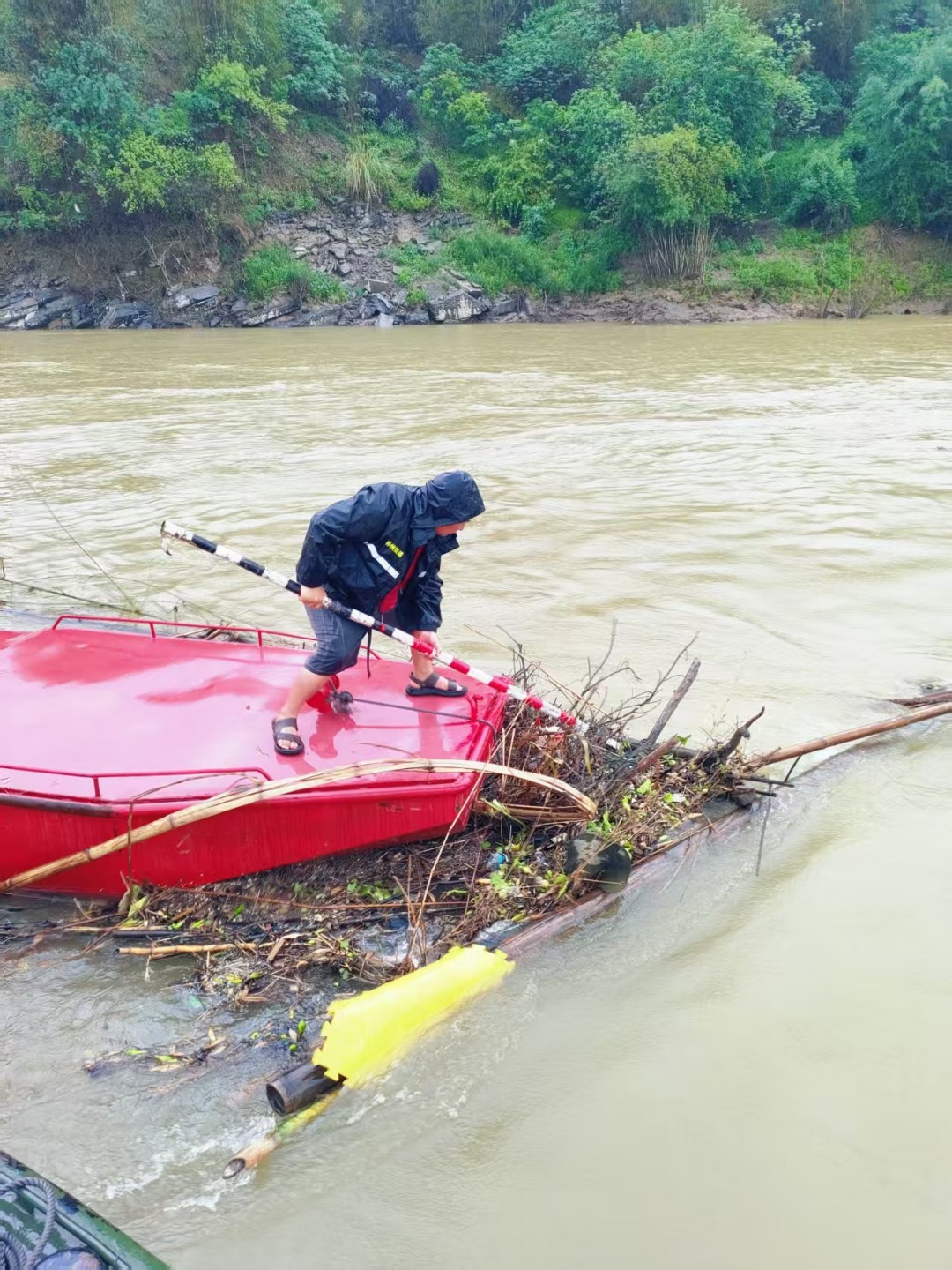1752484080210050831.jpg 4.航标员在汛期清理漂浮物.jpg